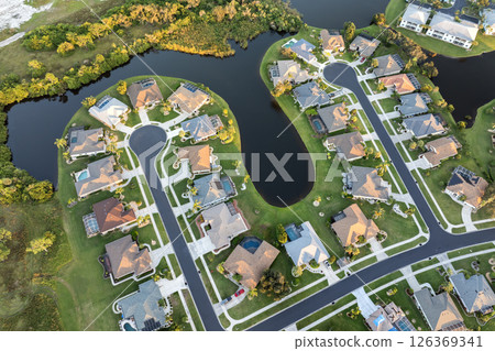 Aerial view of spacious family houses in Florida suburban area. Real estate development in American suburbs Aerial view of spacious family houses in Florida suburban area. Real estate development in American suburbs 126369341