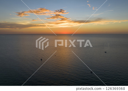 Aerial view of small yachts at sunset floating on sea waves with ripple surface. Motor boats recreation on ocean surface 126369368