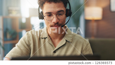 Video call, remote work and man with headset on laptop for conversation, online chat and virtual meeting. Communication, working from home and person for discussion, talking and webinar on computer 126369373