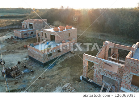 Aerial view of residential houses under construction in rural suburban area. Real estate development 126369385