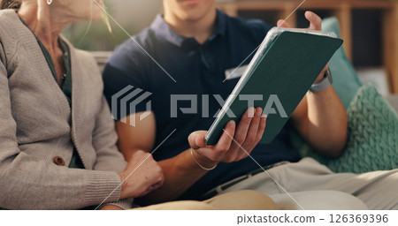 Caregiver, tablet and old woman on sofa with hands, advice and medical consultation in senior care. Conversation, homecare and elderly person on couch with nurse, digital app and health insurance. Caregiver, tablet and old woman on sofa with hands, advice and medical consultation in senior care. Conversation, homecare and elderly person on couch with nurse, digital app and health insurance. 126369396