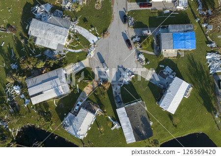 Aerial view of natural disaster consequences. Severely damaged by hurricane Ian mobile homes in Florida residential area Aerial view of natural disaster consequences. Severely damaged by hurricane Ian mobile homes in Florida residential area 126369420