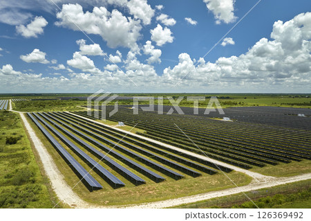 Aerial view of large sustainable electrical power plant with rows of solar photovoltaic panels for producing clean electric energy. Concept of renewable electricity with zero emission 126369492
