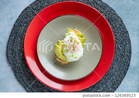 Breakfast of toast with avocado and poached egg 126369523