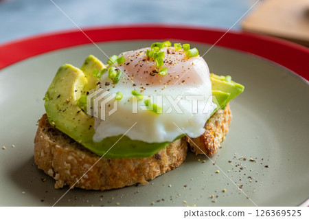 Breakfast of toast with avocado and poached egg 126369525