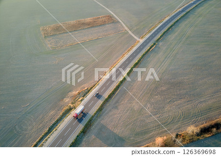 Aerial view of cargo truck driving on highway hauling goods. Delivery transportation and logistics concept 126369698
