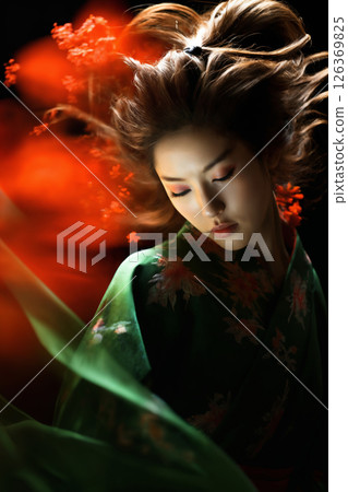 geisha woman with flower in her hair and dressed in green kimono with red flowers, dancing with red cloth on a dark background 126369825