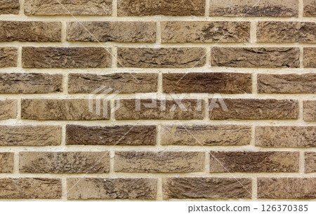 The texture of a brown lined wall . Beautiful fence The texture of a brown lined wall . Beautiful fence 126370385