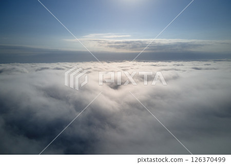 Aerial view from high altitude of earth covered with puffy rainy clouds forming before rainstorm Aerial view from high altitude of earth covered with puffy rainy clouds forming before rainstorm 126370499