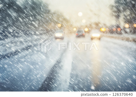 traffic on the background of a snowstorm in winter, a snow-covered road, safety concept on a slippery road 126370640