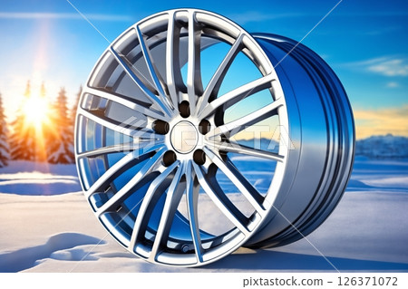 new alloy car wheel on the background of snow and forest, winter season 126371072
