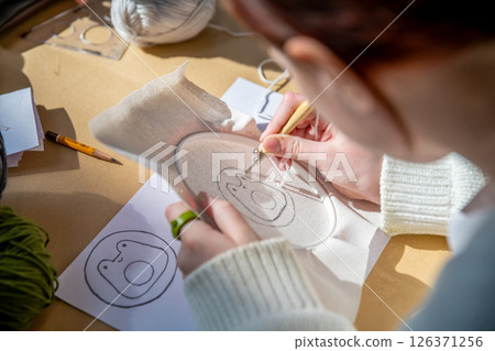 cute teenage girl at carpet embroidery workshop, craft exhibition, craft fair, education, workshops, DIY cute teenage girl at carpet embroidery workshop, craft exhibition, craft fair, education, workshops, DIY 126371256