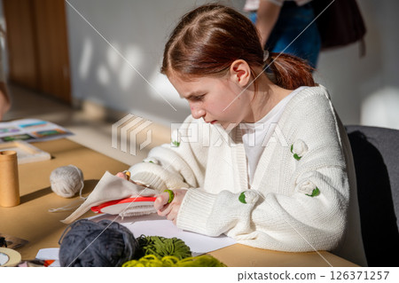 cute teenage girl at carpet embroidery workshop, craft exhibition, craft fair, education, workshops, DIY cute teenage girl at carpet embroidery workshop, craft exhibition, craft fair, education, workshops, DIY 126371257