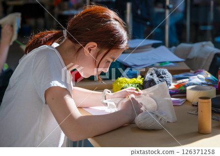 cute teenage girl at carpet embroidery workshop, craft exhibition, craft fair, education, workshops, DIY 126371258