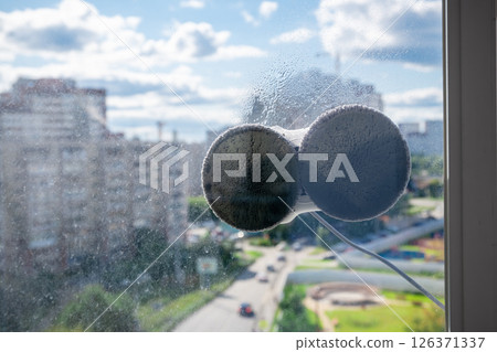 Robot window cleaner washes glass with round rags, robotic service, modern technologies Robot window cleaner washes glass with round rags, robotic service, modern technologies 126371337