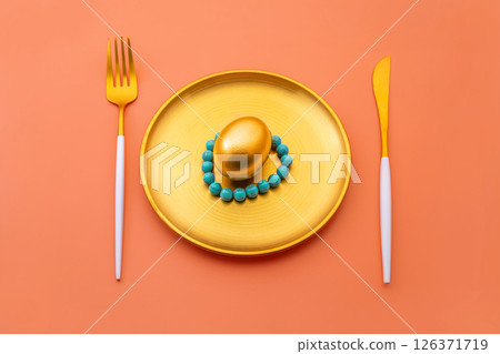 Luxurious golden easter egg is elegantly placed on a golden plate. Accompanied by a matching fork and knife. All arranged on a vibrant pink backdrop. Creating a visually striking and festive scene Luxurious golden easter egg is elegantly placed on a golden plate. Accompanied by a matching fork and knife. All arranged on a vibrant pink backdrop. Creating a visually striking and festive scene 126371719