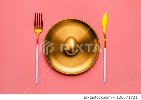 golden egg on golden plate a glistens alongside luxurious cutlery against a vibrant pink background, representing wealth, investment opportunities, and financial success golden egg on golden plate a glistens alongside luxurious cutlery against a vibrant pink background, representing wealth, investment opportunities, and financial success 126371721