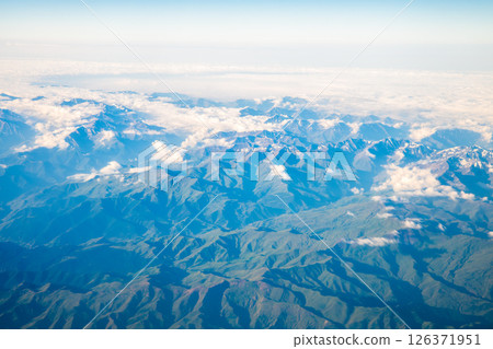 A view of the planet Earth, a view from an airplane, mountains and clouds A view of the planet Earth, a view from an airplane, mountains and clouds 126371951