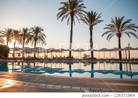 beach umbrellas, sun loungers by the pool, rest, relax, summer vacation beach umbrellas, sun loungers by the pool, rest, relax, summer vacation 126371969