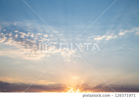 Beautiful sunset or sunrise, sky with clouds, sun rays breaking through the clouds, magical, fabulous natural background, serenity and calm Beautiful sunset or sunrise, sky with clouds, sun rays breaking through the clouds, magical, fabulous natural background, serenity and calm 126371971