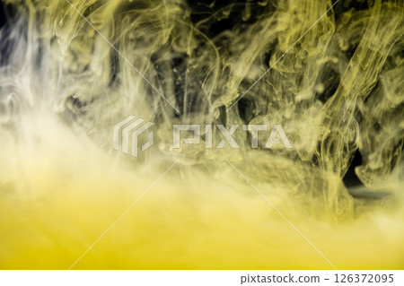 clouds of yellow smoke on a black background, clouds of paint in water, aquarium, abstract background, texture clouds of yellow smoke on a black background, clouds of paint in water, aquarium, abstract background, texture 126372095