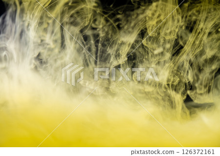 clouds of yellow smoke on a black background, clouds of paint in water, aquarium, abstract background, texture 126372161