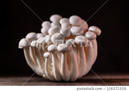 Closeup of a bunch of shimeji mushrooms on dark background, with selective focus Closeup of a bunch of shimeji mushrooms on dark background, with selective focus 126372328