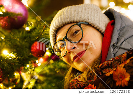 Joyful celebration of the holiday spirit with festive decorations and warm smiles at a winter gathering Joyful celebration of the holiday spirit with festive decorations and warm smiles at a winter gathering 126372358