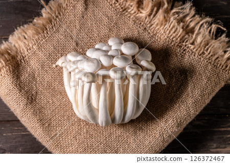 Closeup of a bunch of shimeji mushrooms on wooden background, with selective focus Closeup of a bunch of shimeji mushrooms on wooden background, with selective focus 126372467