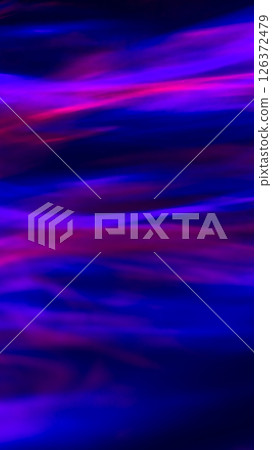 Defocused abstract red, pink and blue background of speed camera movement over glowing lights. A pattern of flashes of light similar to the northern lights 126372479