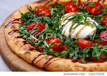 Burrata Arugula Pizza with Cherry Tomatoes Pesto and Balsamic Drizzle Burrata Arugula Pizza with Cherry Tomatoes Pesto and Balsamic Drizzle 126372830