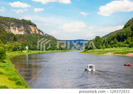 Panoramic scenic view rental boat cruising Elbe river curve Sachsische Schweiz National Park Germany Koenigstein Whelen mountain valley blue sky sunny day. Europe travel nature landscape destination Panoramic scenic view rental boat cruising Elbe river curve Sachsische Schweiz National Park Germany Koenigstein Whelen mountain valley blue sky sunny day. Europe travel nature landscape destination 126372831
