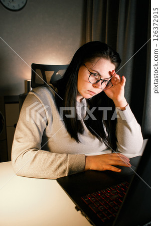 Tired new entrepreneur trying to deal with business problems. Upset businesswoman feeling tired of unsuccess selling products. Woman with laptop. Online business concept. Tired new entrepreneur trying to deal with business problems. Upset businesswoman feeling tired of unsuccess selling products. Woman with laptop. Online business concept. 126372915