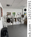 Corner of an art classroom filled with plaster busts, drawings, and student easels 126372991