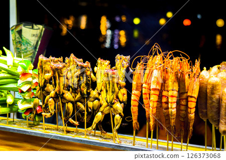 Colorful Night Market Skewers, Grilled Frogs, Prawns, Vegetables, and Sausages, Asian Street Food Colorful Night Market Skewers, Grilled Frogs, Prawns, Vegetables, and Sausages, Asian Street Food 126373068