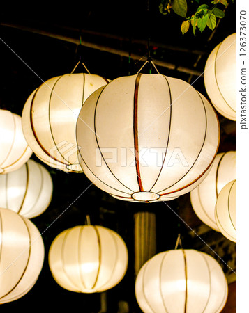 Glowing Lanterns in the Night, Traditional Chinese White Silk Lanterns Illuminate Warm, Soft Light 126373070