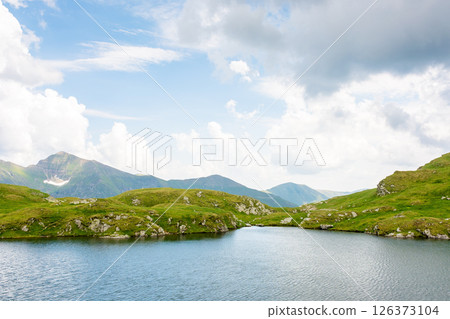alpine lake capra in summer. outdoor adventure. cloudy weather. scenery of fagaras ridge. carpathian mountain range. romania landscape. transylvania alps green environment 126373104