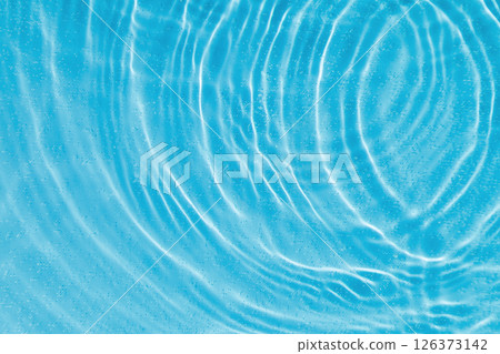 drops on water with circles on a blue background drops on water with circles on a blue background 126373142