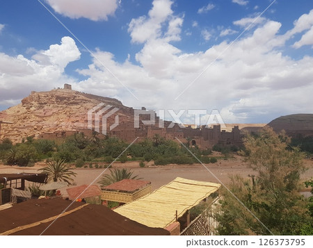 A small town in a vast desert, surrounded by beautiful mountains A small town in a vast desert, surrounded by beautiful mountains 126373795