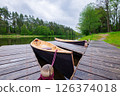 Canoes, kayaks on the bank of the forest river at the marina. Travel and recreation in nature 126374018