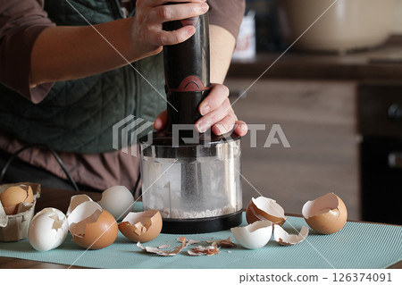 Preparing Eggshell Powder. Woman grinds eggshells with blender. Calcium supplement, cracked eggshell, natural compost ingredient, broken eggshell Preparing Eggshell Powder. Woman grinds eggshells with blender. Calcium supplement, cracked eggshell, natural compost ingredient, broken eggshell 126374091