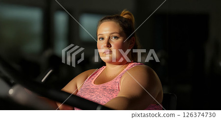 Plus size woman lifting dumbbells and training indoors at the gym, showcasing strength and determination. Generated image 126374730