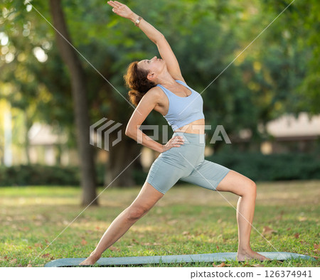 Adult woman doing yoga in park 126374941