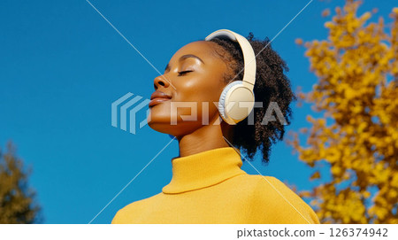 Curvy African woman running in a city park on a crisp autumn morning, wearing headphones.. Generated image 126374942