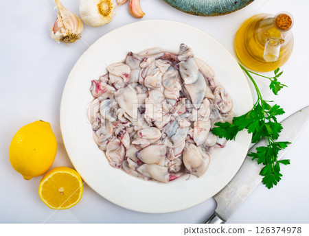 Raw squid, sliced, for a delicious lunch with lemon and garlic Raw squid, sliced, for a delicious lunch with lemon and garlic 126374978