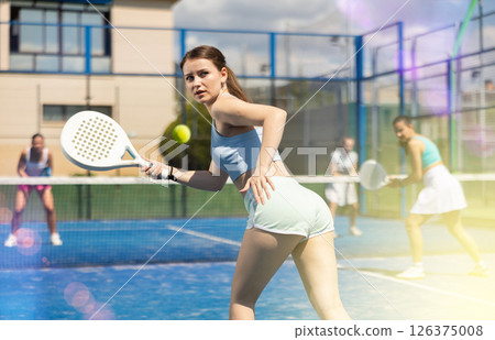 Athletic woman playing racket in paddle tennis weekend in parks 126375008