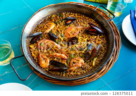 Seafood paella in metal pan 126375011