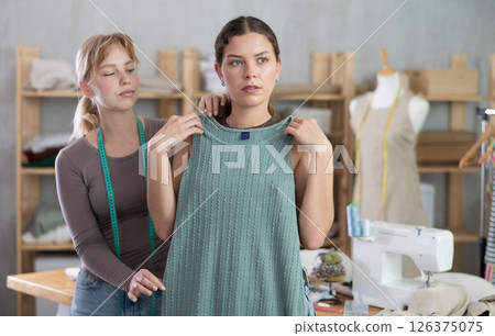 tailor together with the client check the sewn dress tailor together with the client check the sewn dress 126375075