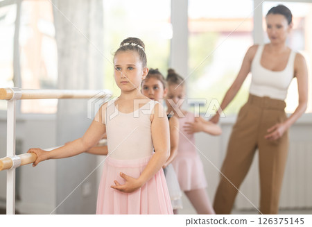 Ballet choreographer teaches little children to get into first position 126375145