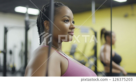 Plus size woman lifting dumbbells and training indoors at the gym, showcasing strength and determination. Generated image 126375203